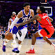 Toronto Raptors guard Armoni Brooks (1) reaches across Philadelphia 76ers forward Tobias Harris (12) in the fourth quarter at Wells Fargo Center.